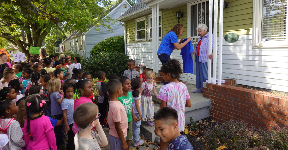 maize students standing outside neighborhood home